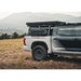 Tundra with a Backwoods roof rack in a field with mountains in the background