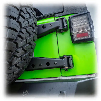Turn Offroad heavy-duty tire carrier mounted on Jeep JK tailgate with large spare