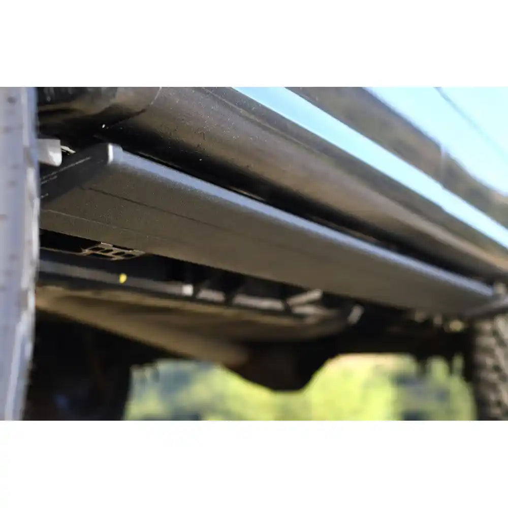 Underbody view of AMP PowerStep Smart Series mechanism installed on Ford F-150 Raptor