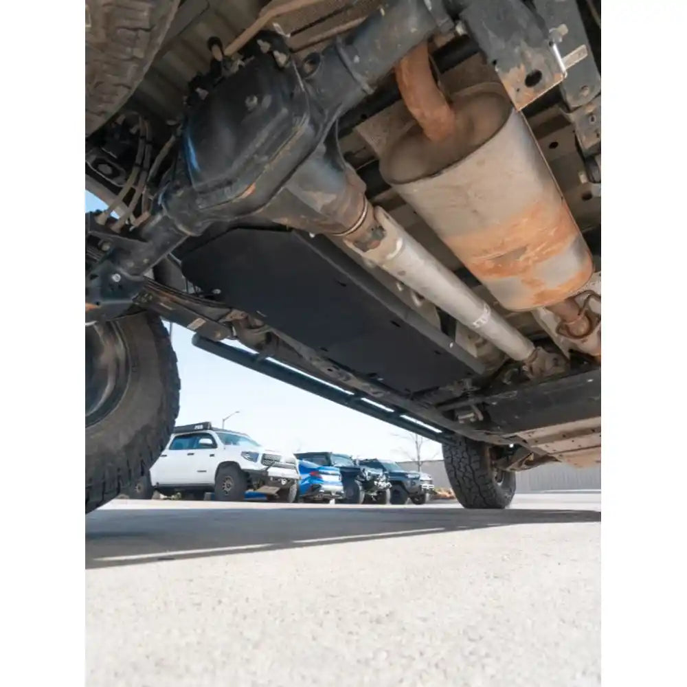 Underbody view of installed black RCI fuel tank skid plate on Colorado near rear axle