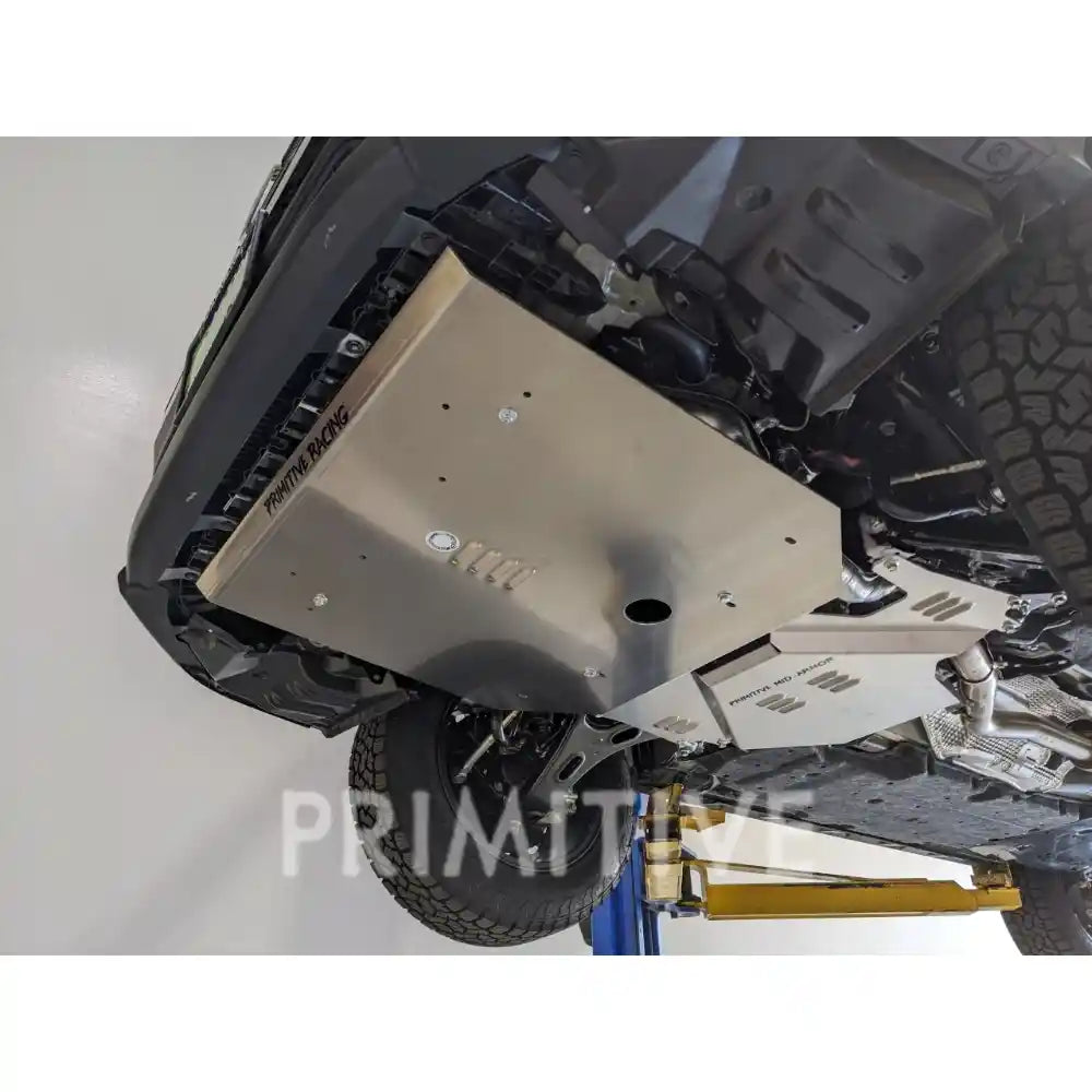 Undercarriage of a Crosstrek with a protective skid plates on a white background, featuring the brand 'Primitive'.
