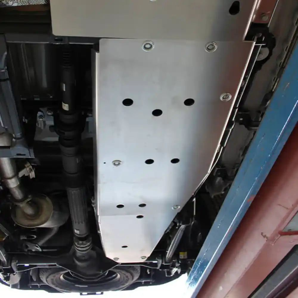 Underside view of Jeep Gladiator JT with Asfir fuel tank skid plate installed on rocky terrain.