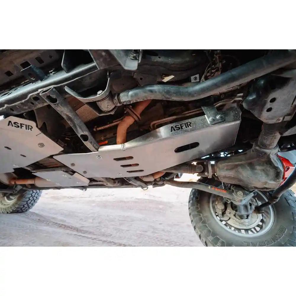 Underside view of a Jeep Gladiator JT with Asfir aluminum skid plates fully installed, covering the engine, transmission, transfer case, and fuel tank