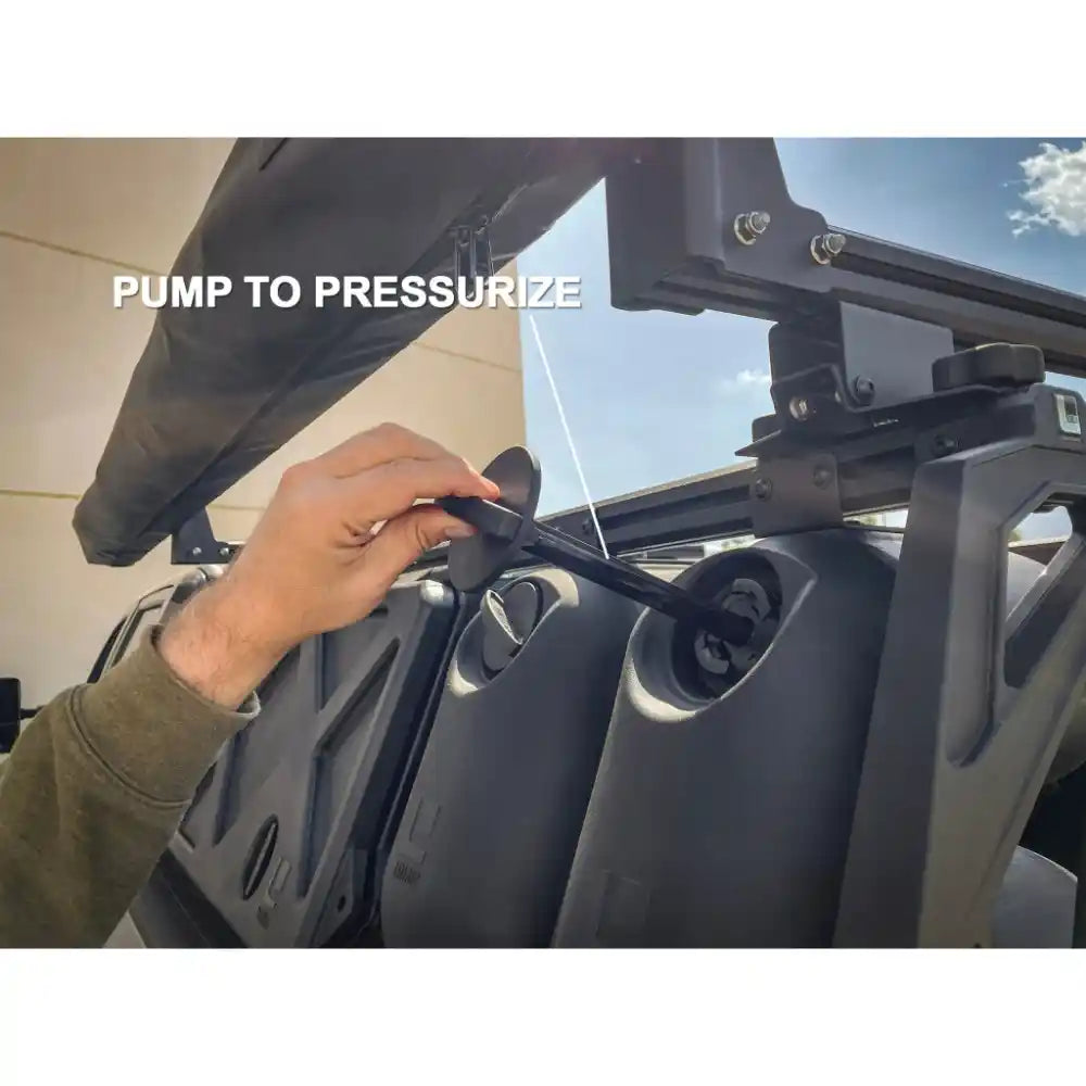 User pressurizing HydroPOD CARRY shower system by hand pump