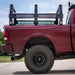 Red truck with a variable length Truss bed rack on a clear day