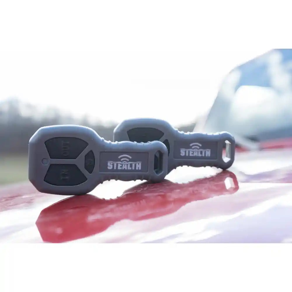 Two gray 'Stealth' winch remotes