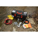 Warrior Winch Trojan kit with toolbox, cables, and gloves on a rocky surface