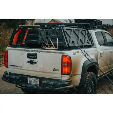 White Chevy with ACS Bed Rack carrying cargo.