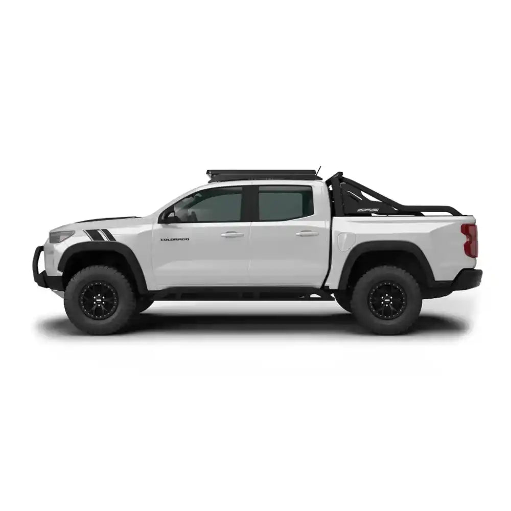 White Colorado truck with installed roof rack on a white background