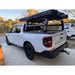 White Ford Maverick truck with an bed rack cargo on a driveway.