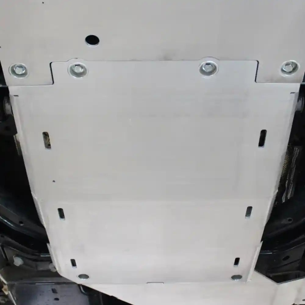 White RCI transmission skid plate bolted under Bronco chassis midsection
