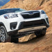 White Subaru Forester mounted with Asfir Front Skid Plate driving on a rocky terrain
