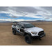 White Toyota Tacoma with RCI Offroad HD bed rack installed in desert setting