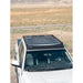 White Tundra parked in open prairie with mounted RCI roof rack against fence