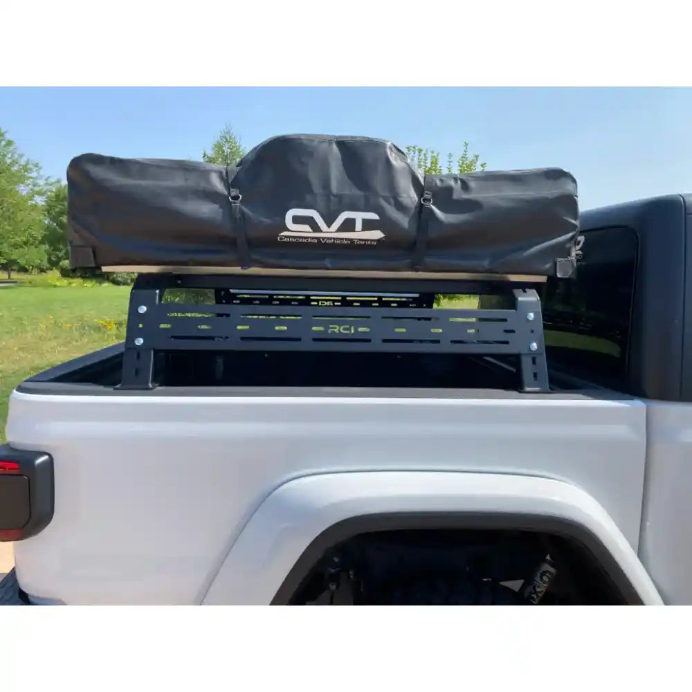 White truck with RCI rack and rooftop tent, rear view