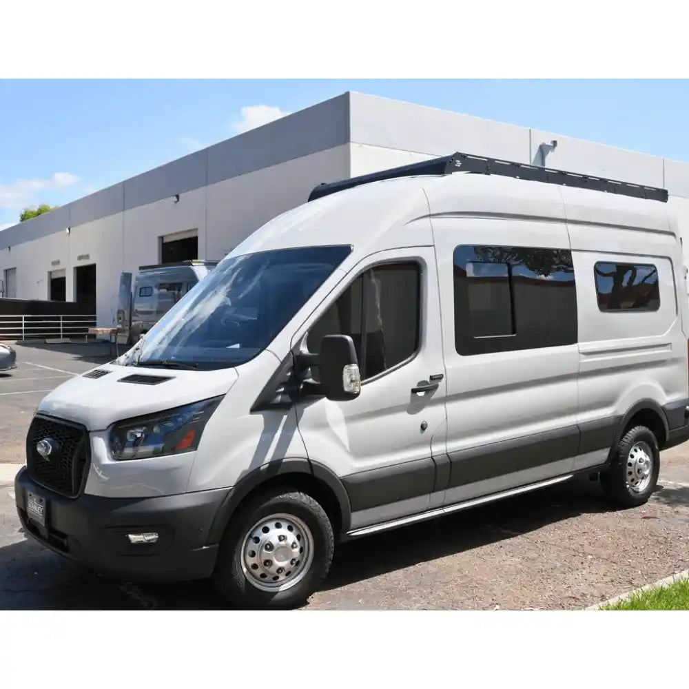 White van with roof rack in a parking lot