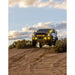 Yellow RCI-protected Ranger climbing rocky dirt path.