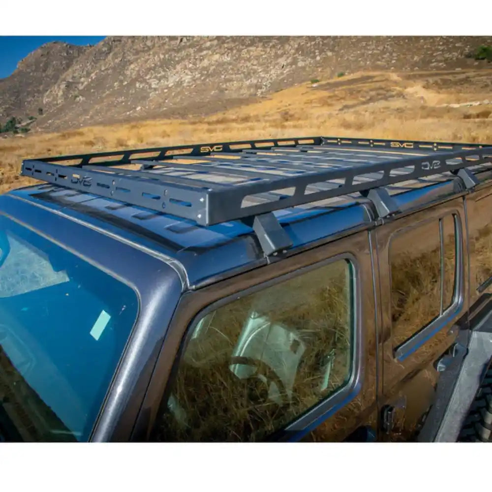 Blue Jeep Wrangler JL 4-Door with the DV8 Offroad Roof Rack, parked in the desert