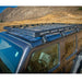 Blue Jeep Wrangler JL 4-Door with the DV8 Offroad Roof Rack, parked in the desert