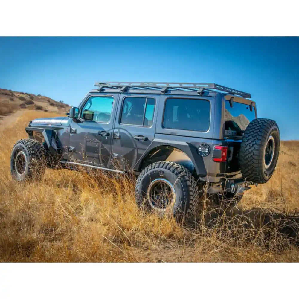 Gray Jeep Wrangler JL 4-Door with the DV8 Offroad Roof Rack, rear three-quarter off-road shot in tall grass