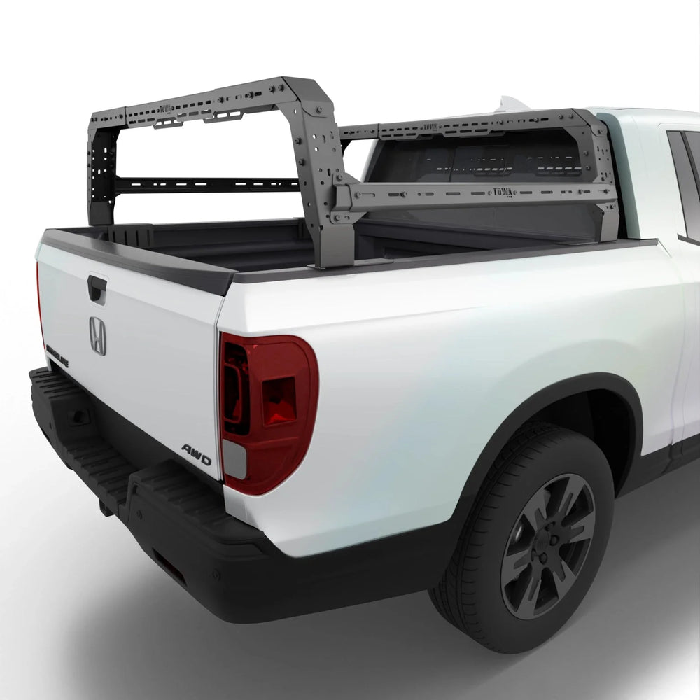 White Honda Ridgeline with a bed rack on a white background