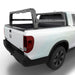 White Honda Ridgeline with a bed rack on a white background