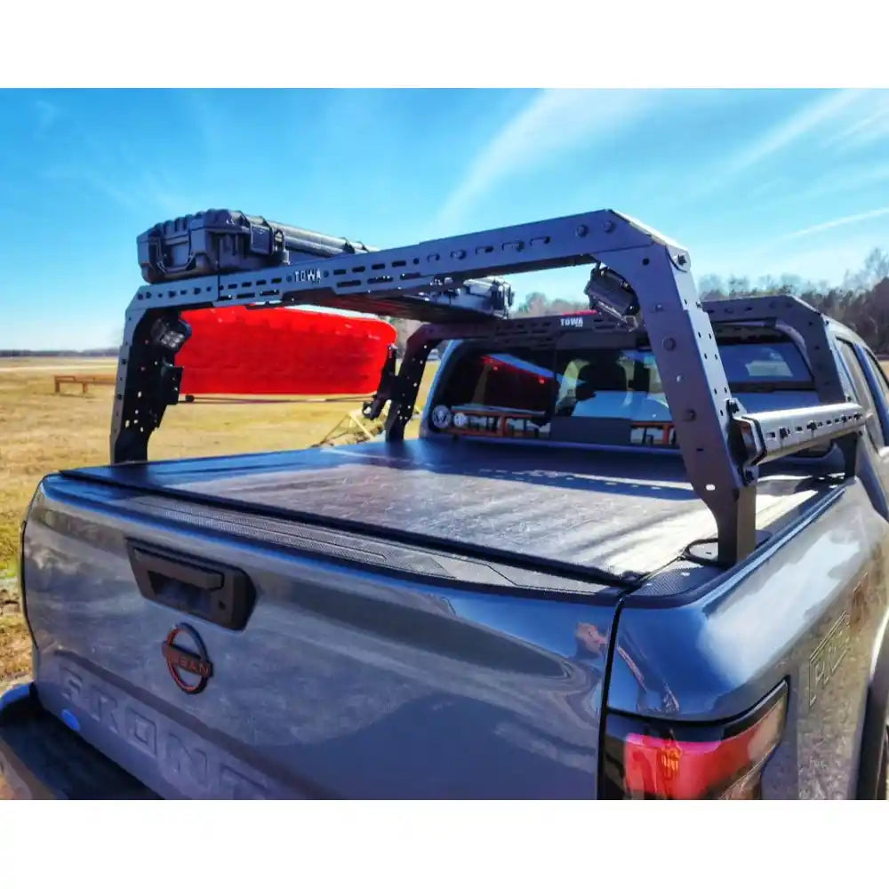 Truck height adjustable bed rack and red toolbox against a blue sky