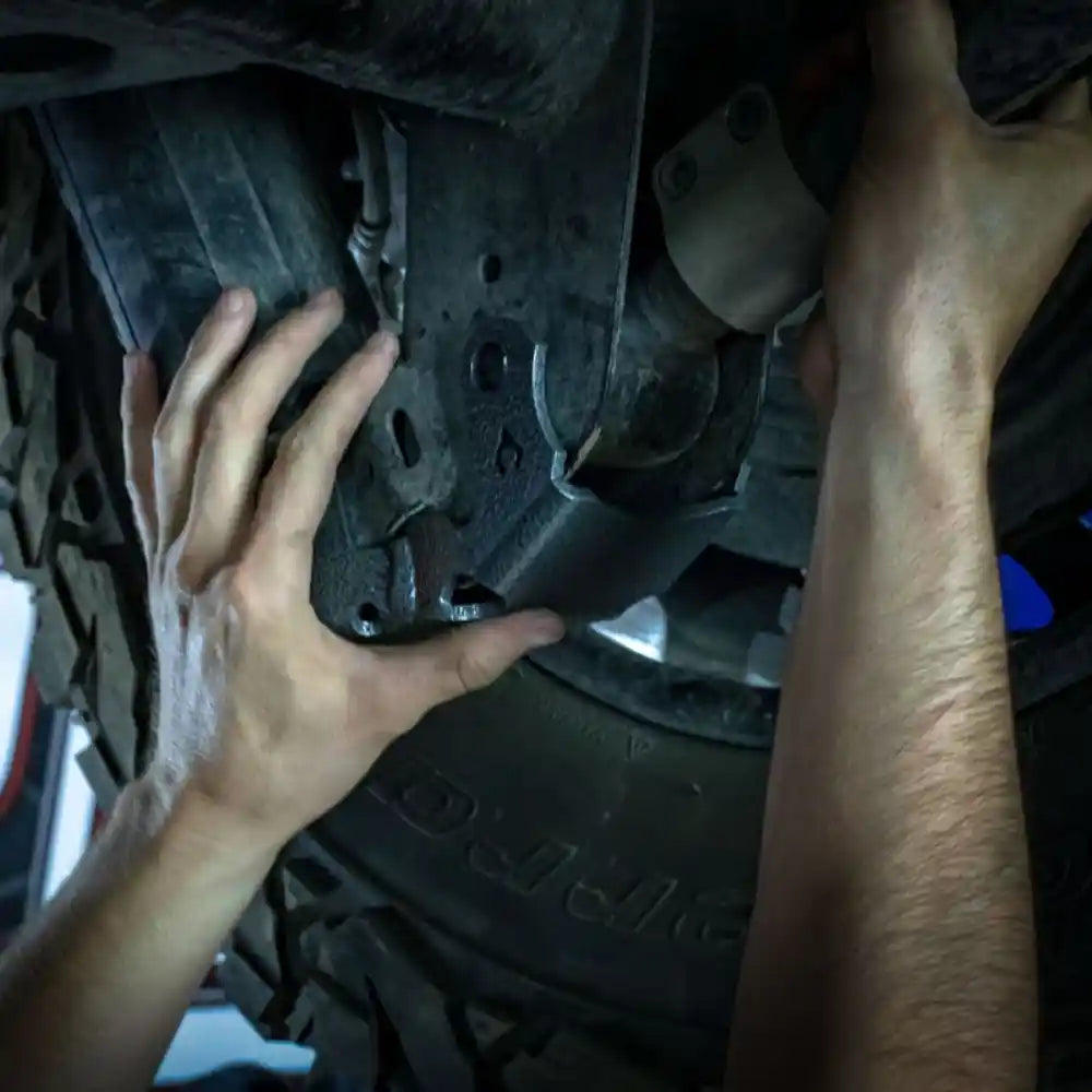 Person installing axle skid plate