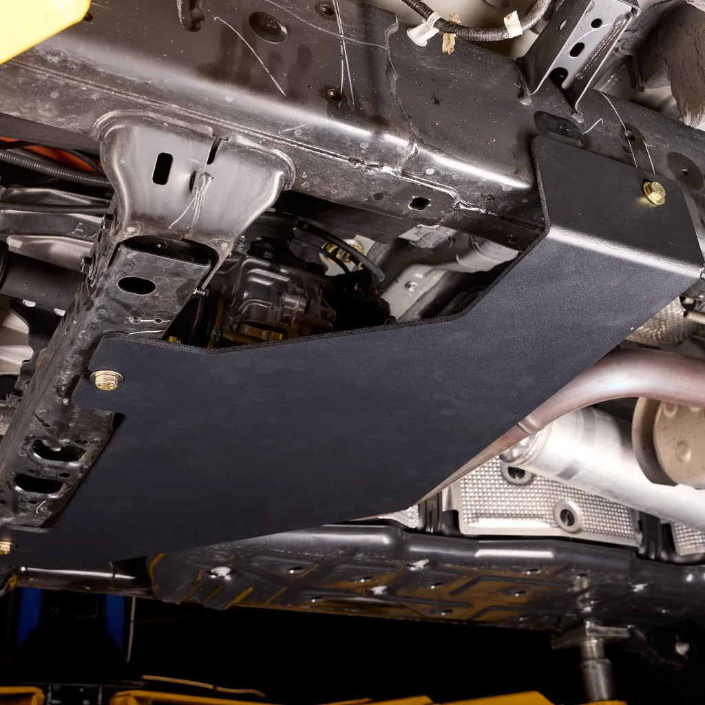 Close-up of the no-drill bolt-on mounting hardware attaching the skid plate to the 4Runner's factory frame points
