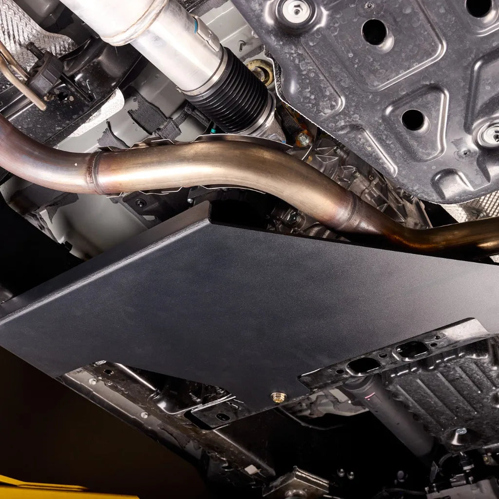 Close-up detail of the Juggernaut transfer case skid plate's aluminum construction and powder-coated finish