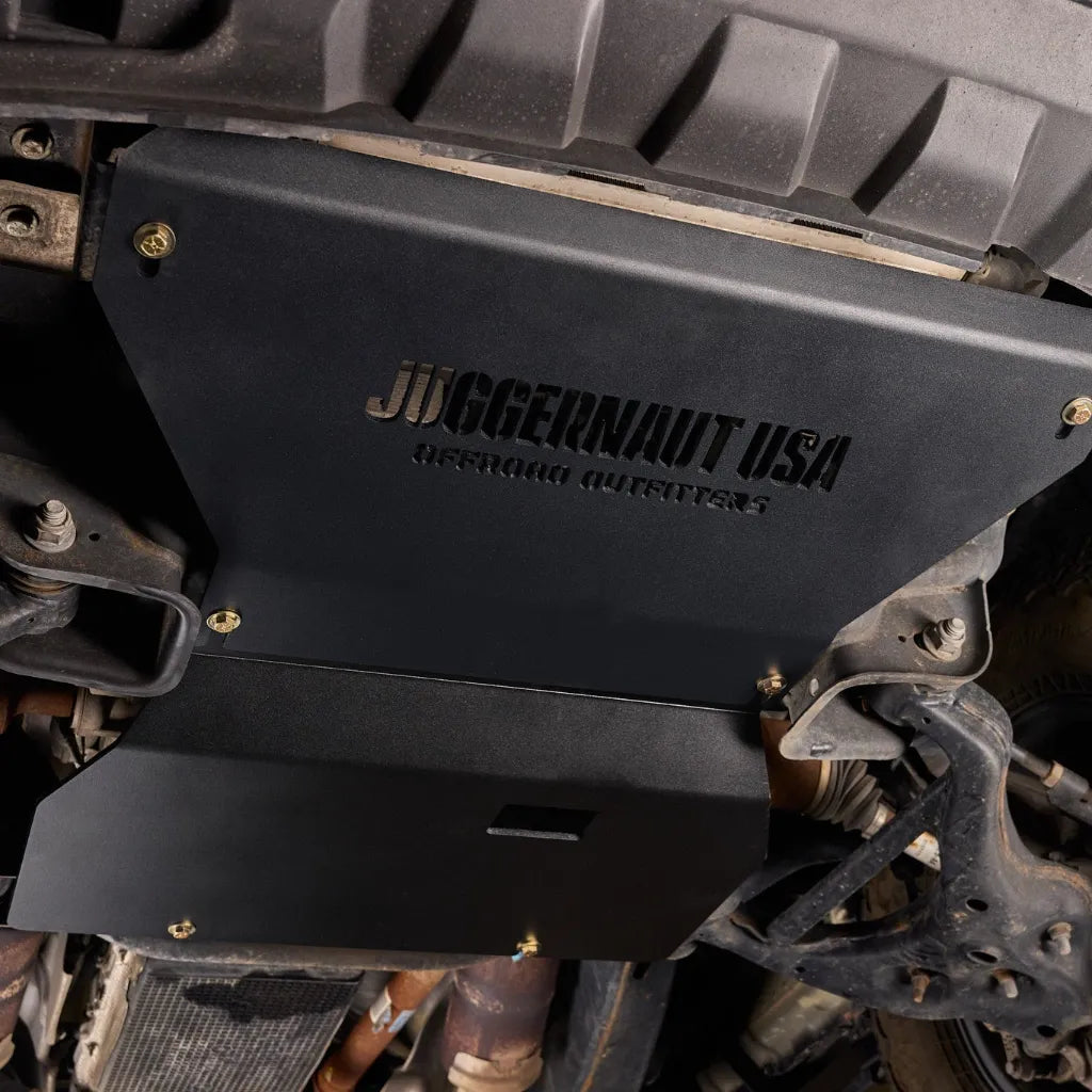 Close-up of the Juggernaut engine skid plate bolted to the Ford Expedition frame rails