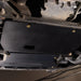 Underside view of a Ford Expedition showing the Juggernaut engine skid plate covering the oil pan and intercooler area