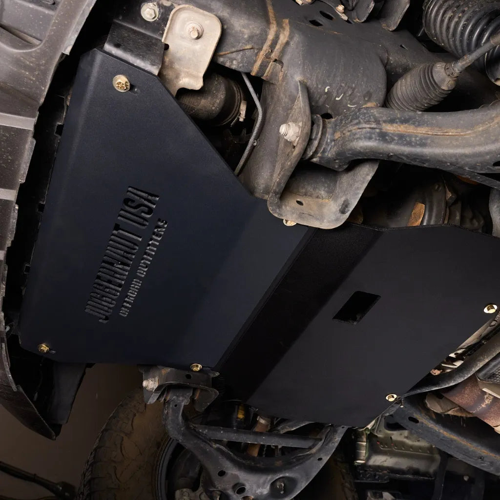 Angled underbody shot of the Juggernaut engine skid plate installed on a Ford Expedition