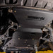 Underside view of a Ford Expedition showing the Juggernaut full skid plate package covering engine, transmission, and transfer case