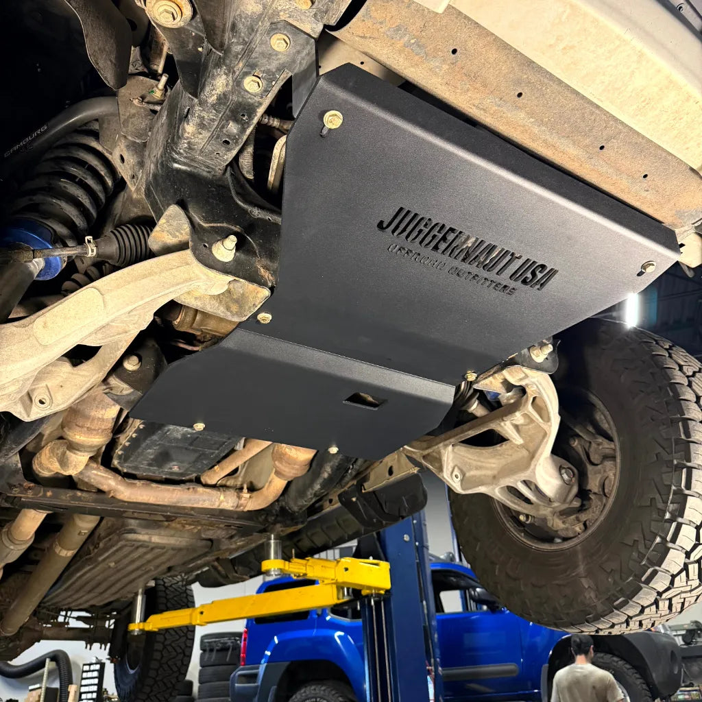 Juggernaut engine skid plate installed near the front suspension of a 2009-2014 Ford F-150
