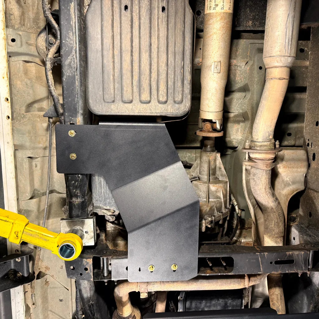 Juggernaut transfer case skid plate installed on the driver side frame rail of a 2009-2014 Ford F-150