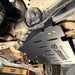 Juggernaut transmission skid plate installed along the rear frame rail of a 2009-2014 Ford F-150