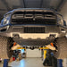 Juggernaut Raptor skid plate package front section installed, covering the oil pan and control-arm mounts