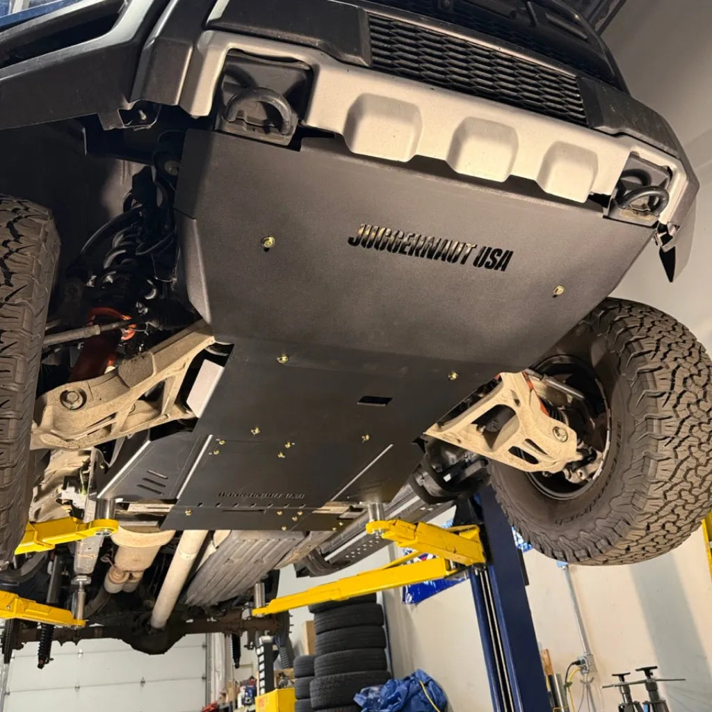 Juggernaut full skid plate package installed underneath a Ford F-150 Raptor, overview of the frame-to-frame underbody armor