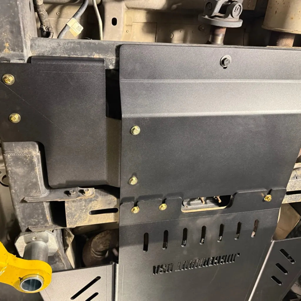 Juggernaut Raptor skid plate package transfer case section installed near the rear of the underbody armor