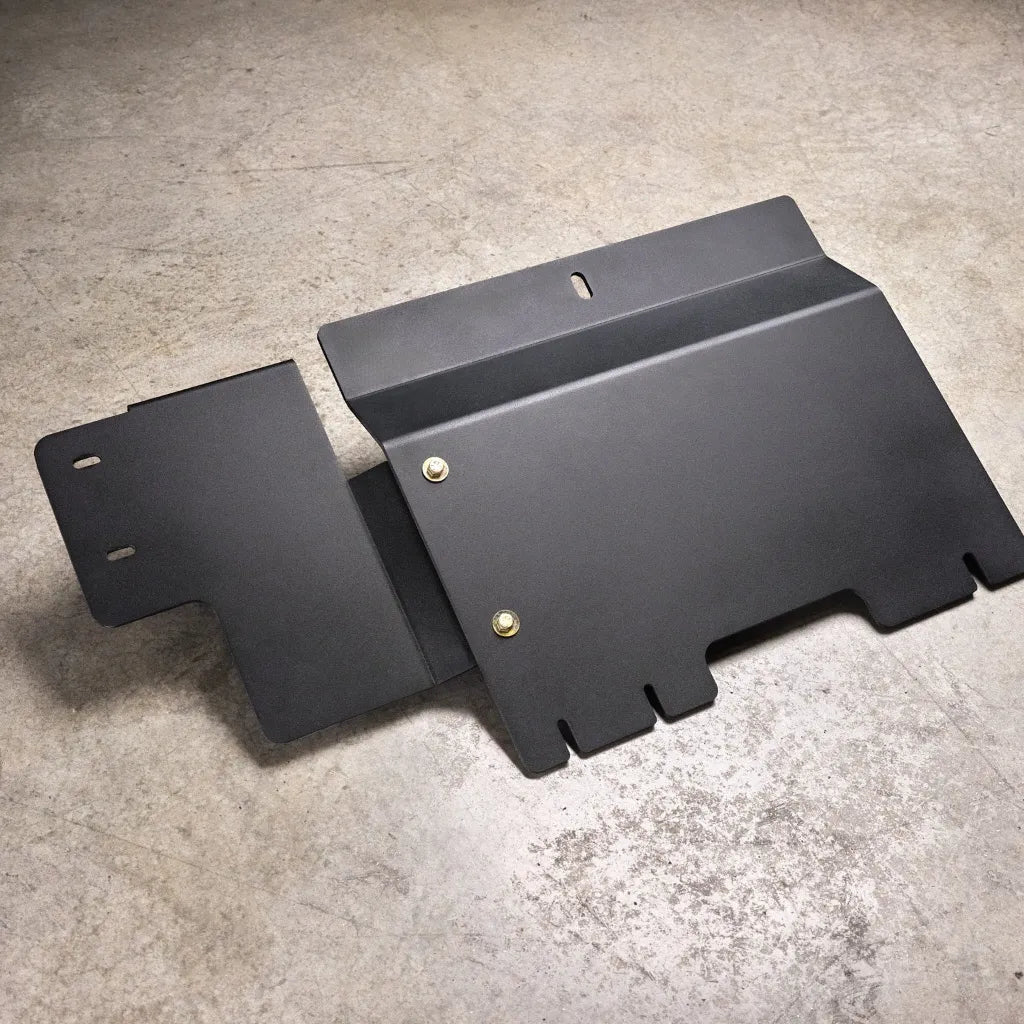 Juggernaut Ford F-150 Raptor transfer case skid plate, product angle shot showing the aluminum plate and mounting brackets