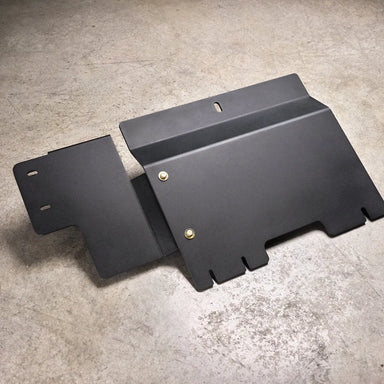 Juggernaut Ford F-150 Raptor transfer case skid plate, product angle shot showing the aluminum plate and mounting brackets