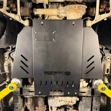 Juggernaut Raptor transmission skid plate installed underneath a Ford F-150 Raptor, covering the transmission and exhaust run