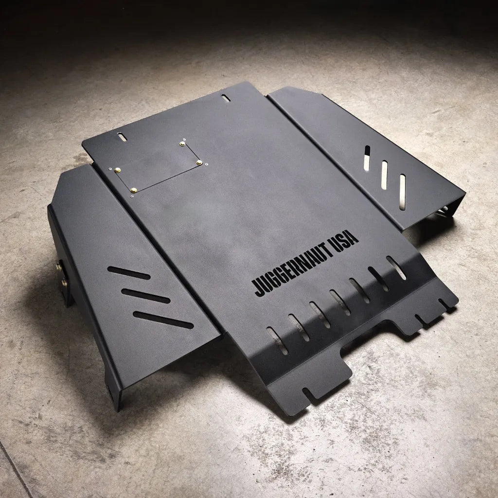 Juggernaut Ford F-150 Raptor transmission skid plate, product angle shot showing the 1/4 inch aluminum plate and crossmember mounting points
