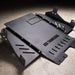 Juggernaut Ford F-150 Raptor transmission skid plate, second angle showing the powder-coated black finish and oil-drain cutout