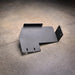 Standalone Ford F-150 transfer case skid plate product view on shop floor, showing the angled bracket shape