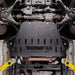 Juggernaut Ford F-150 transmission skid plate installed, wide underbody view showing the front differential and CV axles