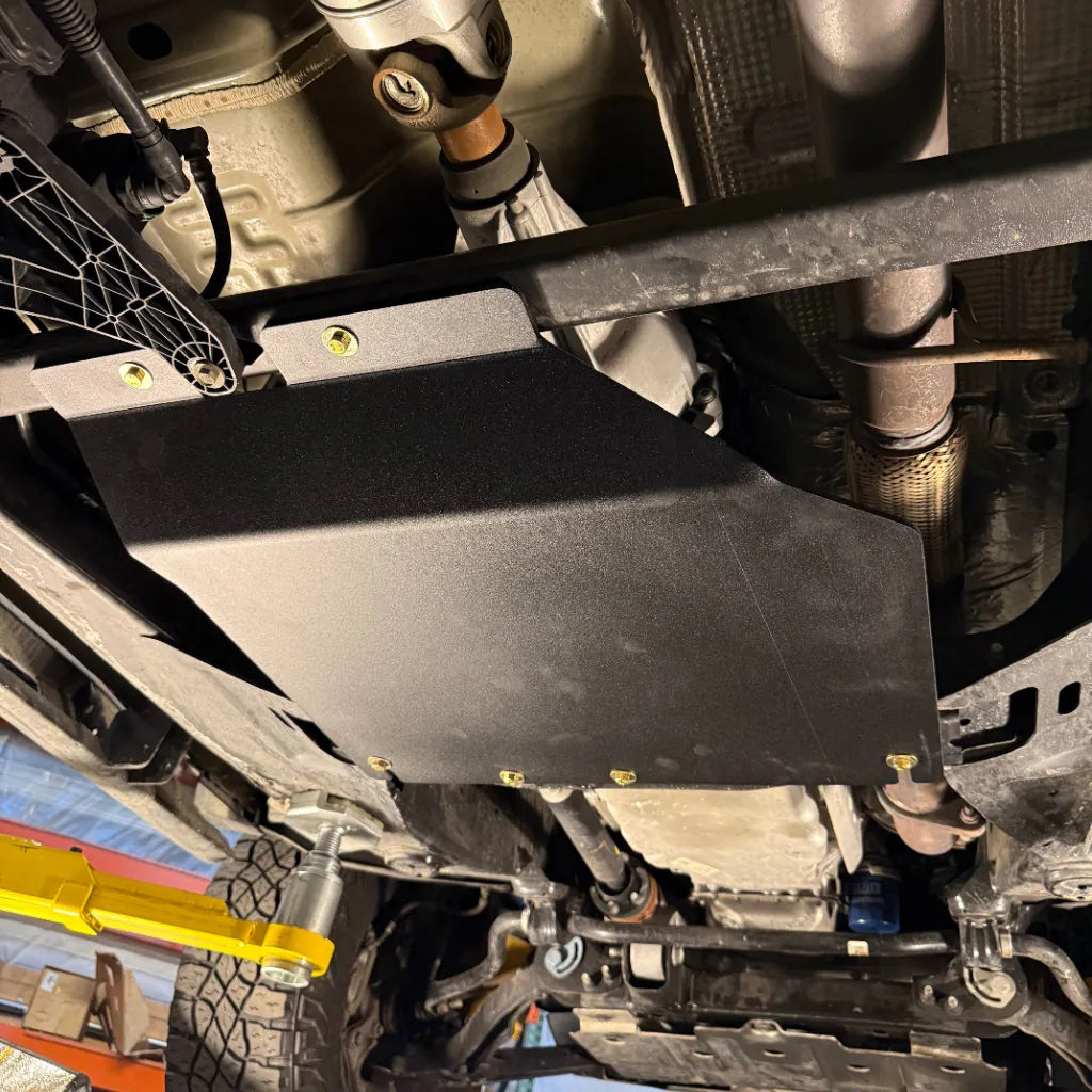 Close-up of the Juggernaut GMC Canyon transfer case skid plate mounting points