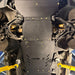 Close-up of the Juggernaut GMC Canyon transmission skid plate showing the oil drain access panel