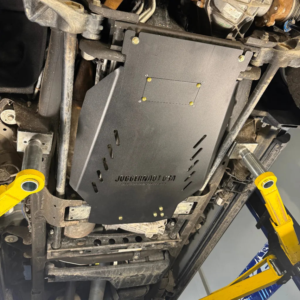 Juggernaut GMC Sierra 2500HD/3500HD transmission skid plate showing the oil drain access panel
